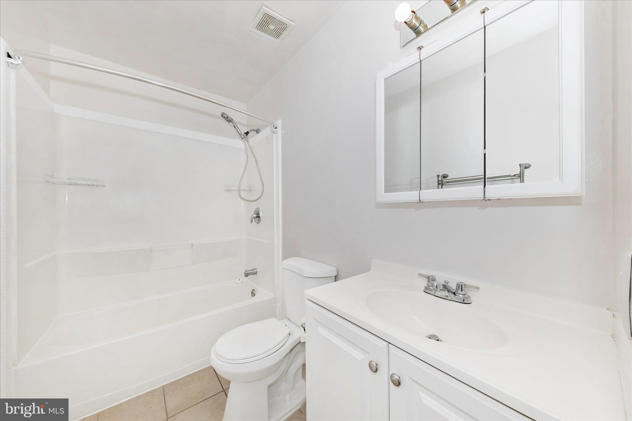 9989 Ridgeline Drive Montgomery Village, MD 20886 - Photo 20 of 26 a bathroom with a sink a toilet and shower