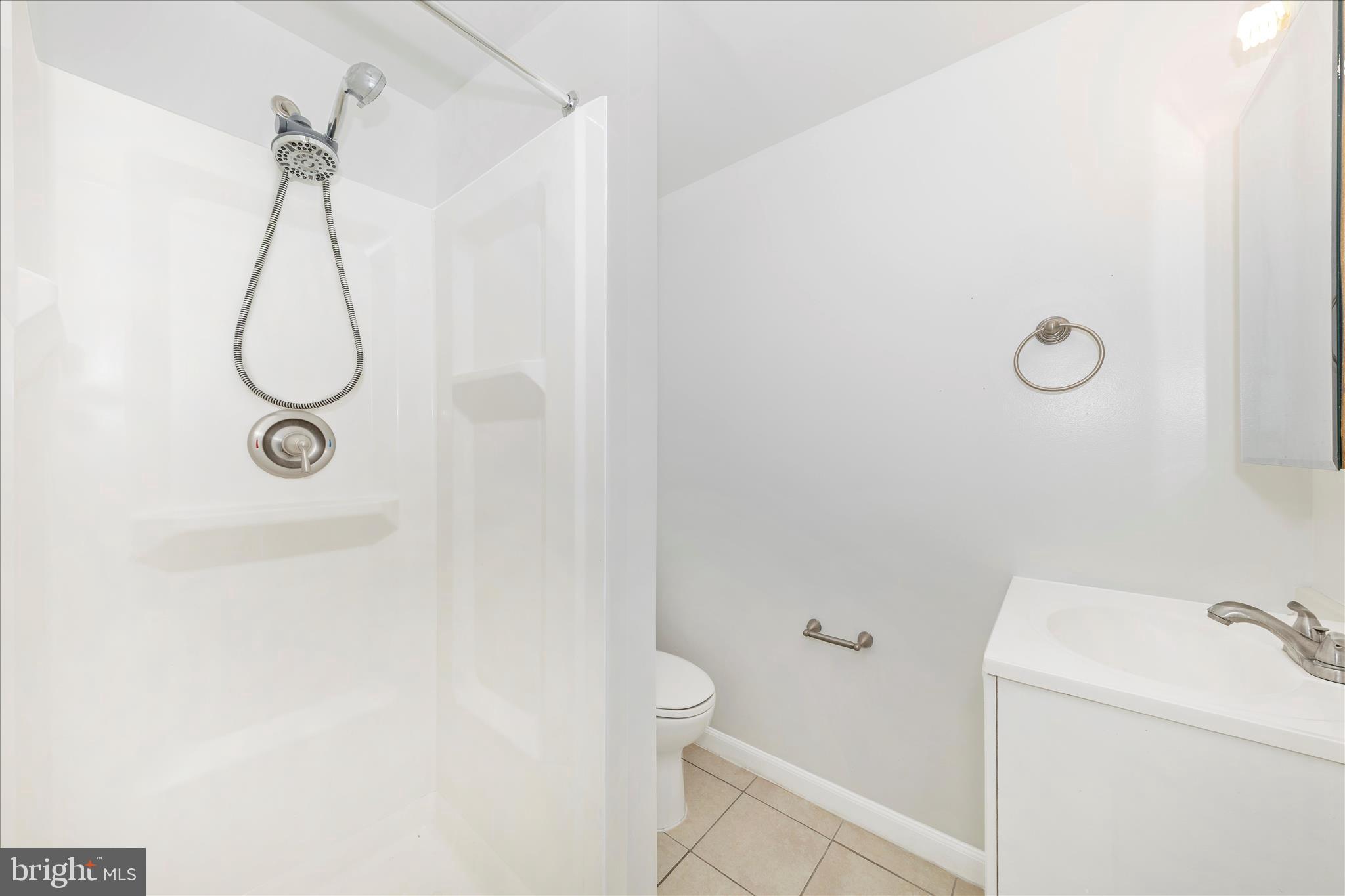 9989 Ridgeline Drive Montgomery Village, MD 20886 - Photo 24 of 26 a bathroom with a shower a toilet and a shower