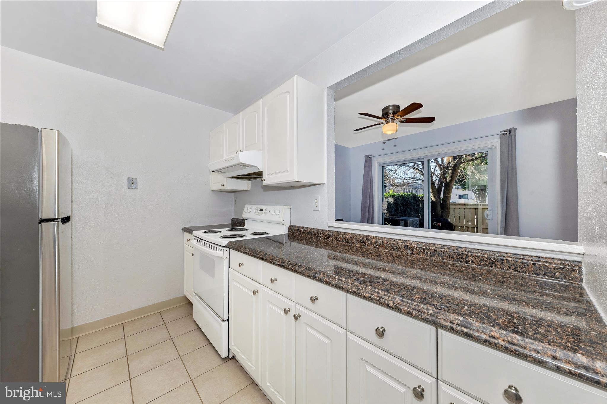 9989 Ridgeline Drive Montgomery Village, MD 20886 - Photo 10 of 26 a kitchen with granite countertop a sink stainless steel appliances and cabinets