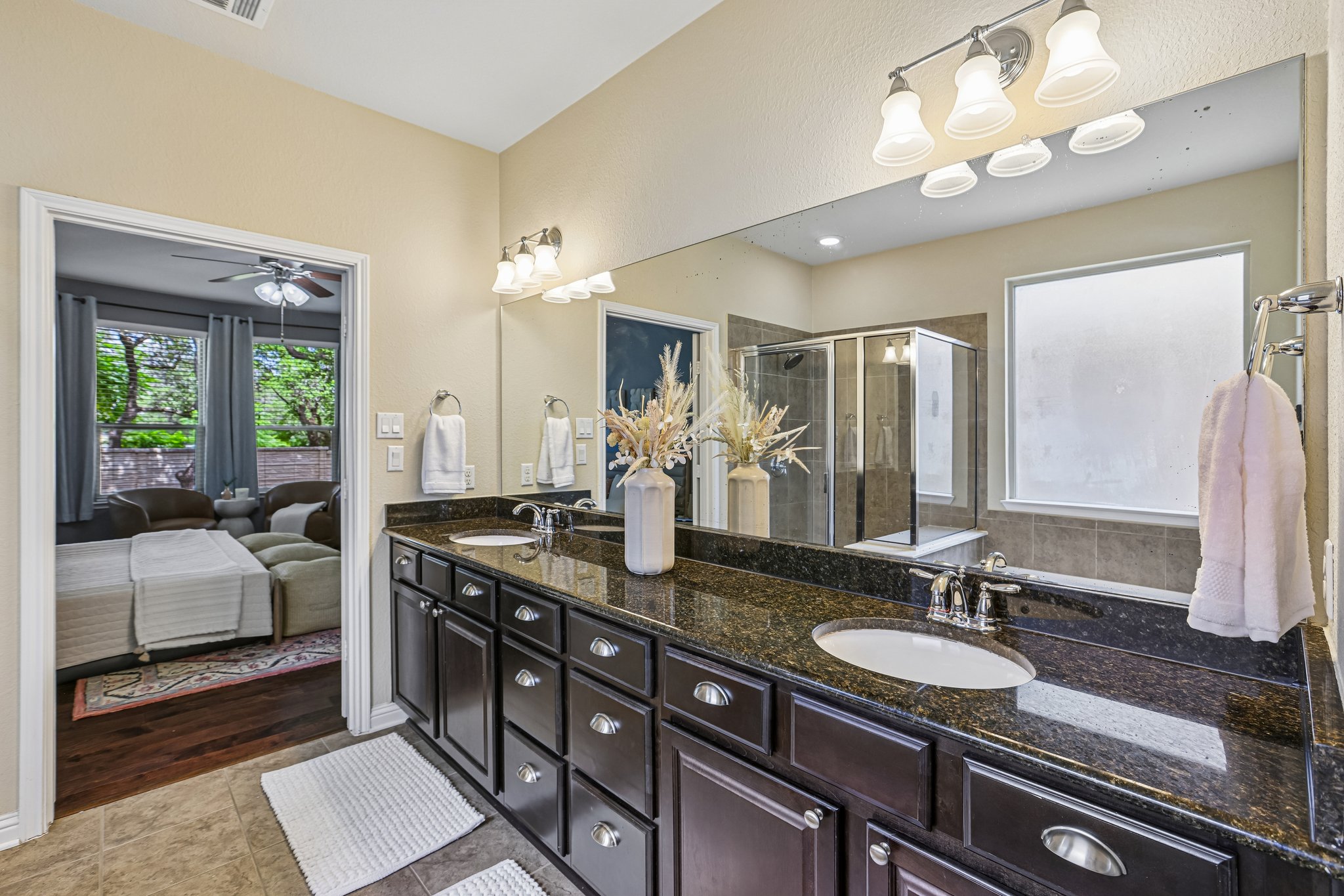 1924 Granite Springs Road Leander, TX 78641 - Photo 16 of 36 Double vanity with stone countertops and ample storage creates a well-appointed primary bathroom.