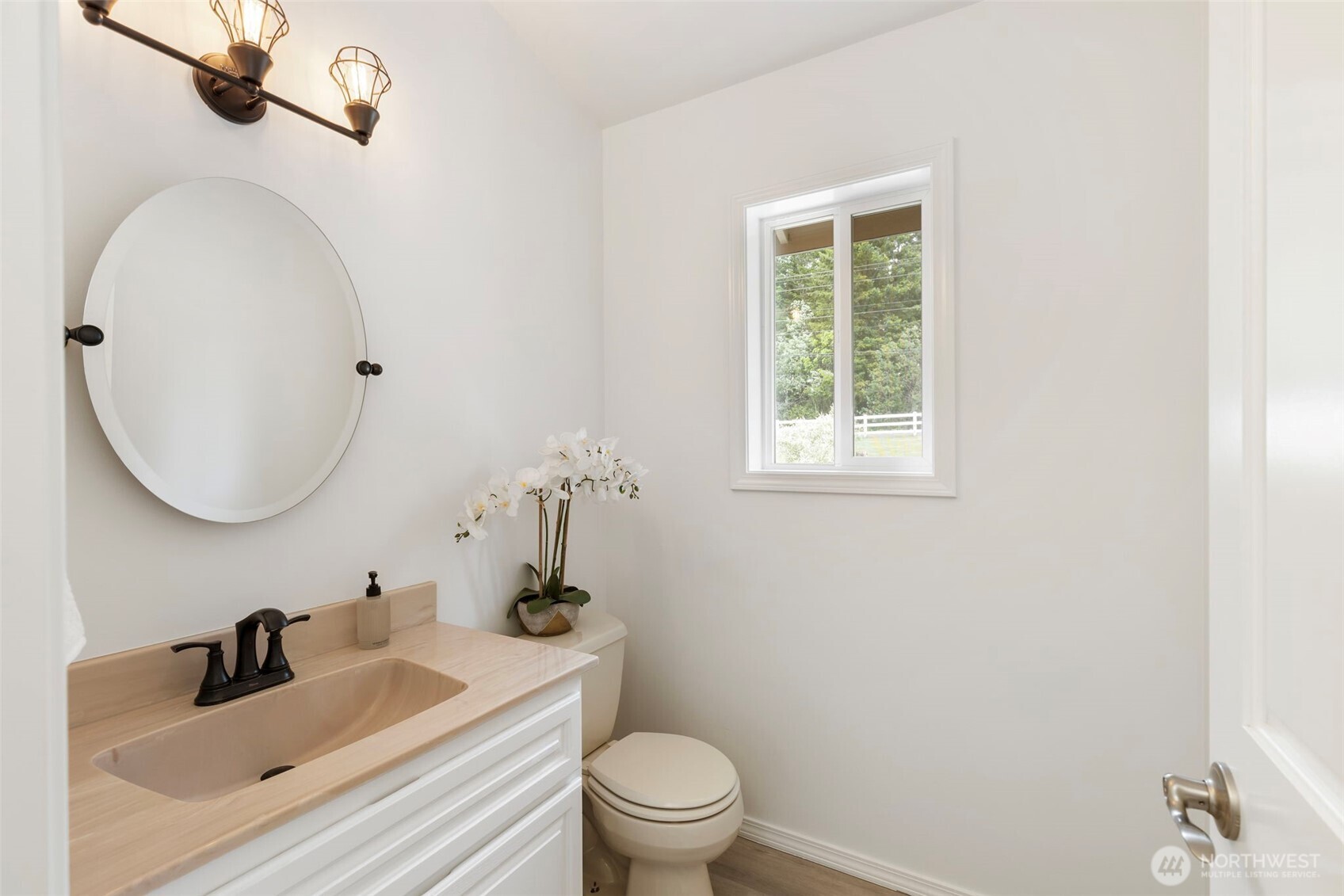 14110 Glenwood Road Southwest Port Orchard, WA 98367 - Photo 7 of 40 a bathroom with a toilet a sink a mirror and a window