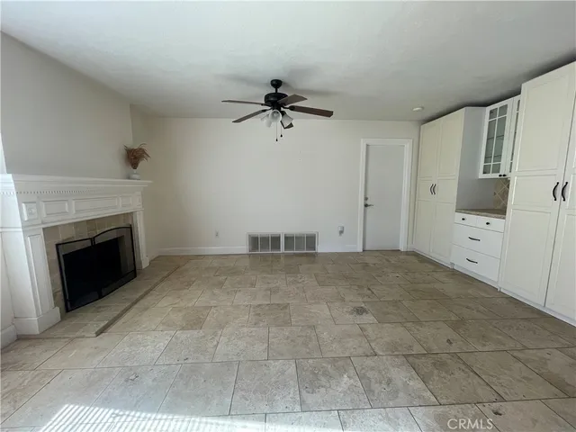 a view of a livingroom with a fireplace and window