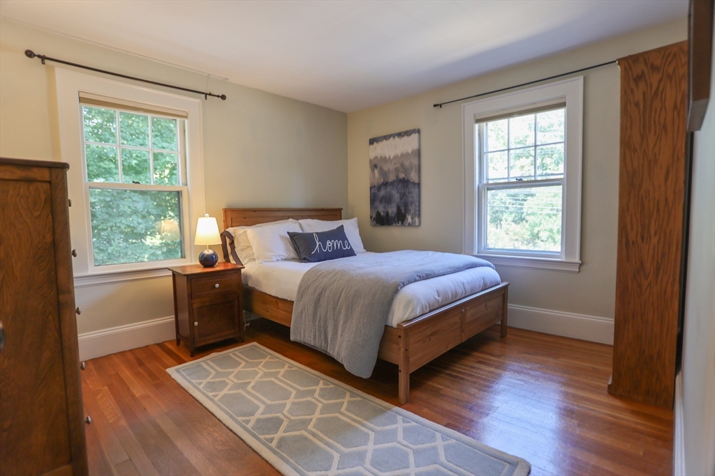 462 Marrett Road Lexington, MA 02421 - Photo 17 of 29 a bedroom with a large bed and a window