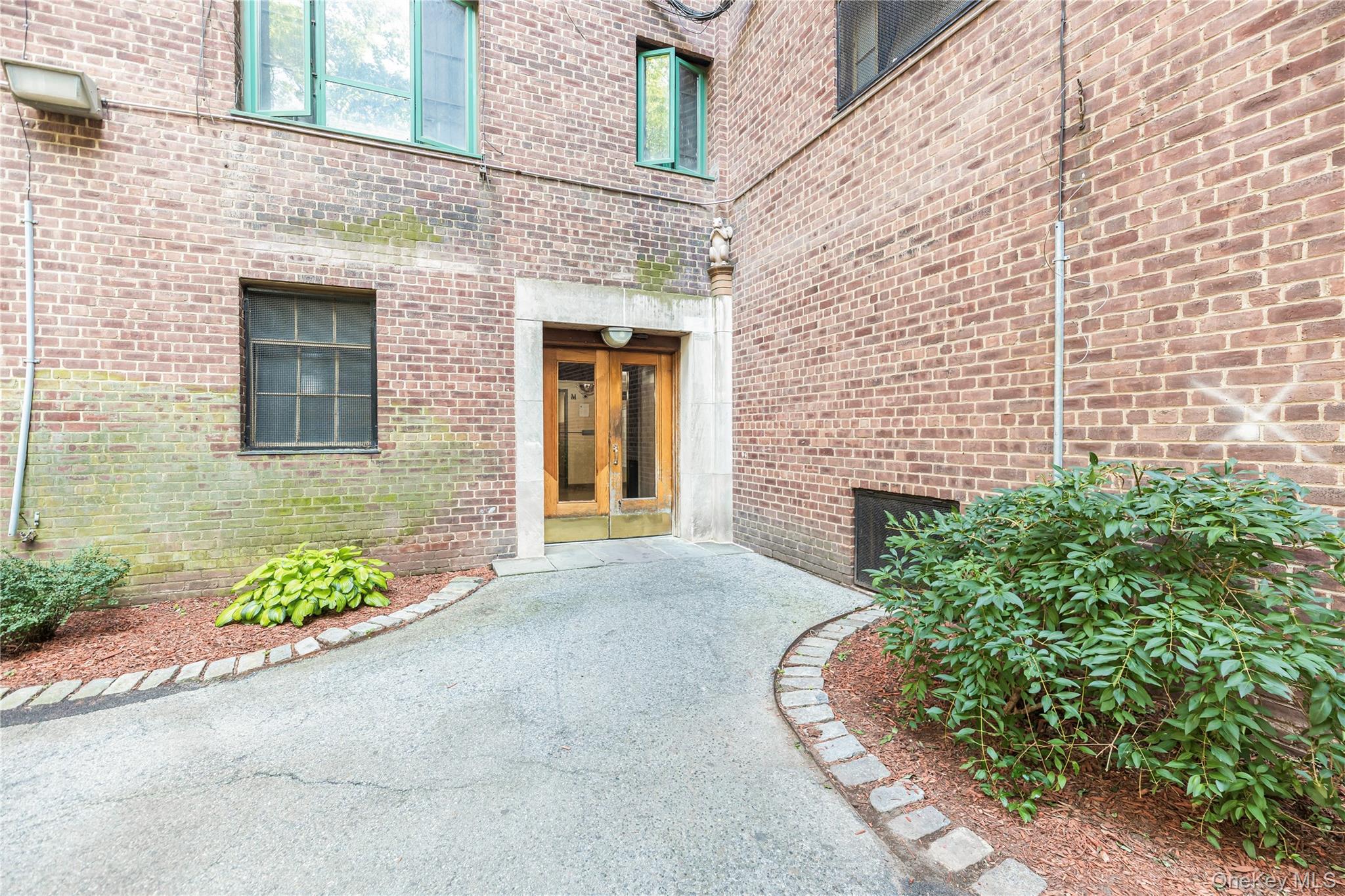 1540 Unionport Road, Unit 7F Bronx, NY 10462 - Photo 11 of 16 a front view of a house with a garden