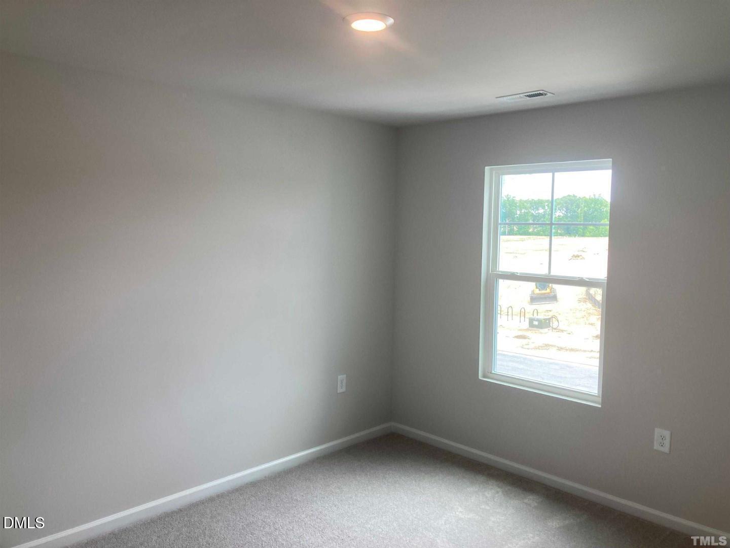1823 Caen Street Raleigh, NC 27610 - Photo 4 of 13 an empty room with a window