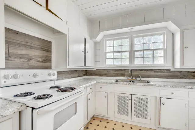 a kitchen with stainless steel appliances granite countertop a sink stove and cabinets