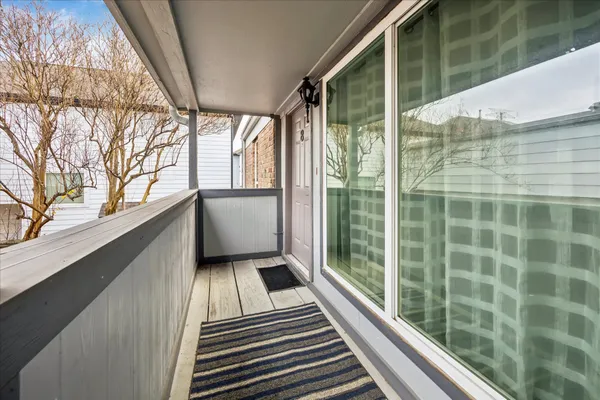 a view of balcony with wooden floor and fence