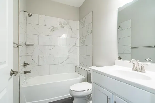 a bathroom with a sink a toilet and a bathtub