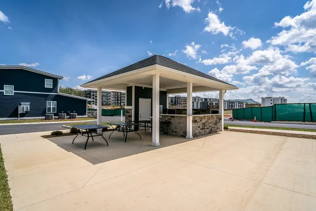 a view of a patio with dining table and chairs with wooden fence