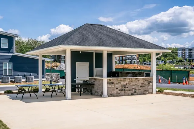 a front view of a house with sitting area