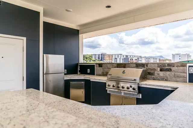 a kitchen with a stove a refrigerator and a sink