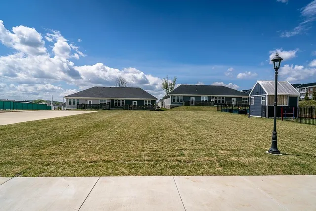 a view of a house with swimming pool and a yard