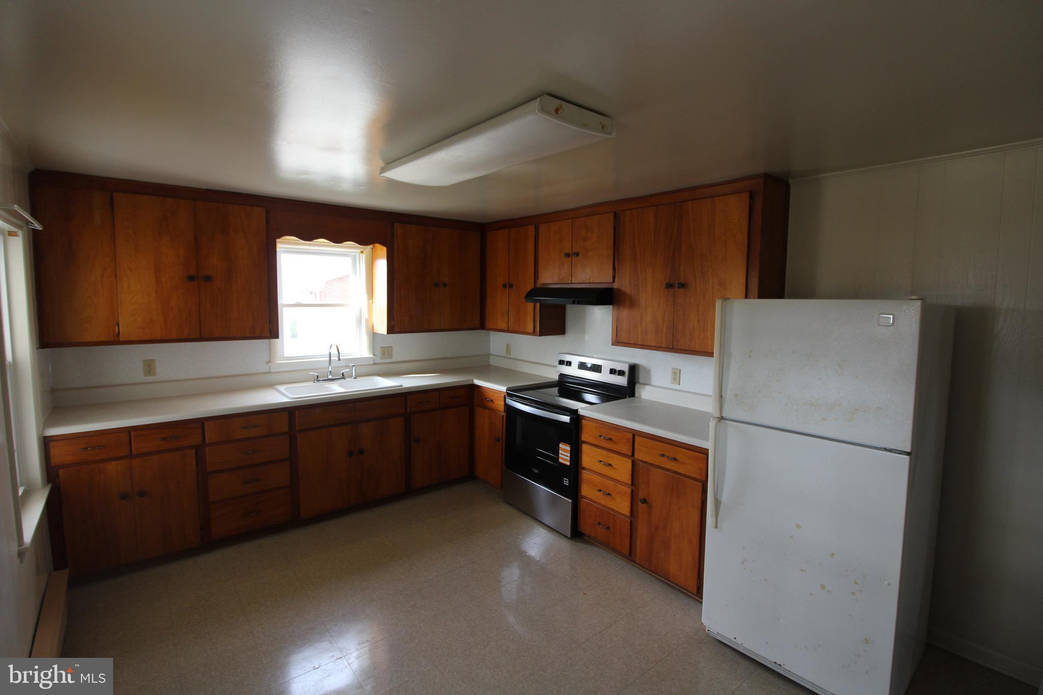 19801 Senedo Road Edinburg, VA 22824 - Photo 5 of 16 a kitchen with stainless steel appliances granite countertop a refrigerator a sink a stove a microwave a sink and cabinets