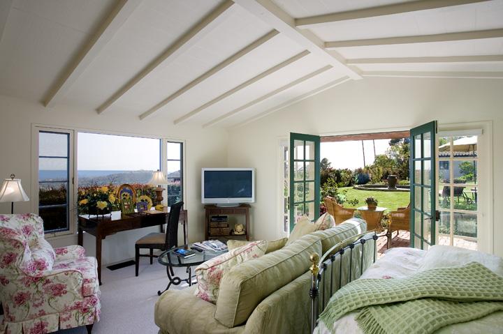 1233 Mission Ridge Road Santa Barbara, CA 93103 - Photo 3 of 8 a living room with furniture a flat screen tv and a floor to ceiling window
