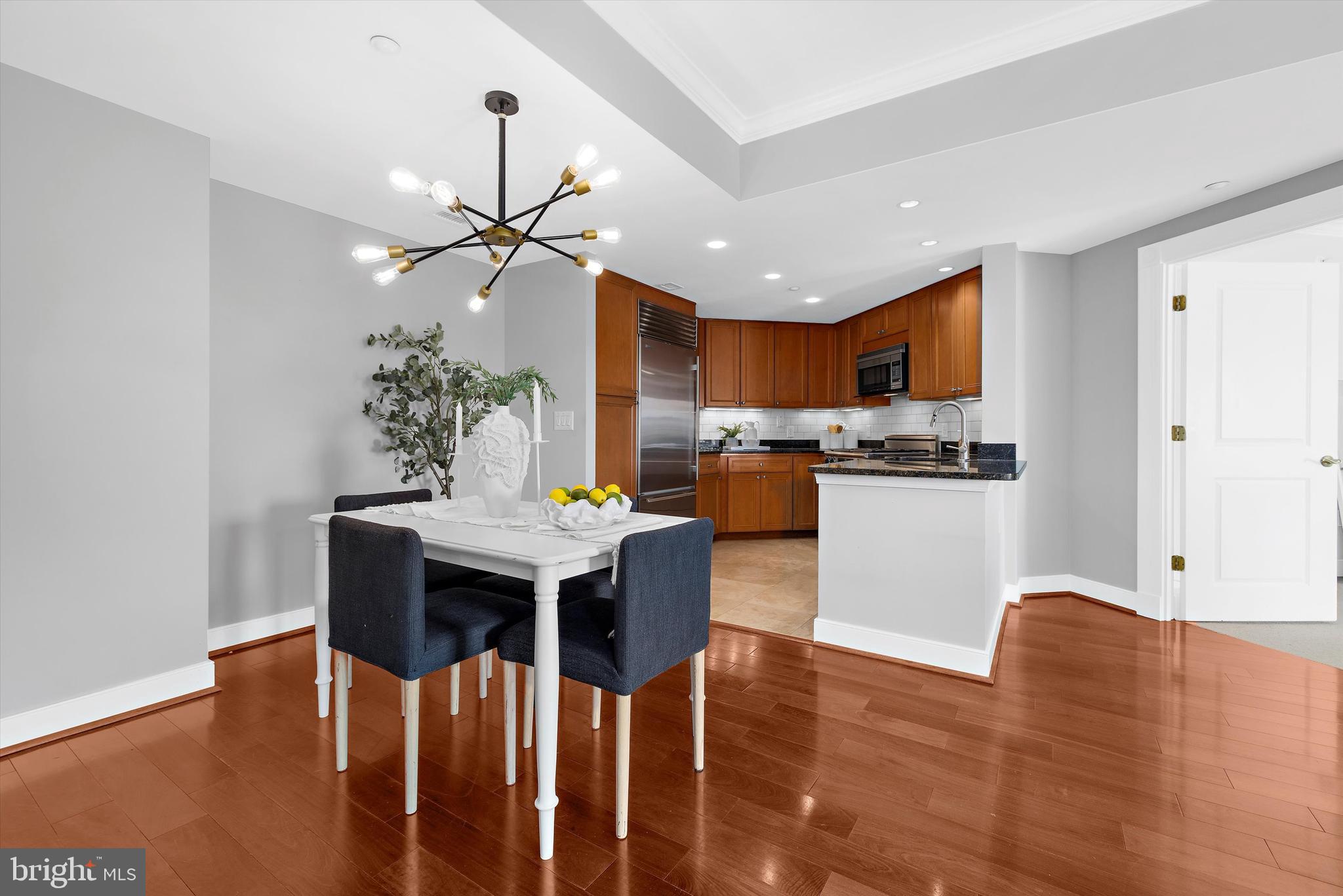 5 Park Place, Unit 702 Annapolis, MD 21401 - Photo 11 of 55 a view of a dining room with furniture and wooden floor