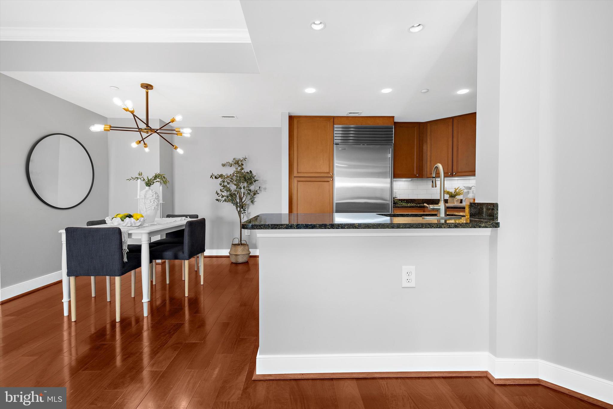 5 Park Place, Unit 702 Annapolis, MD 21401 - Photo 12 of 55 a living room with furniture a mirror and wooden floor