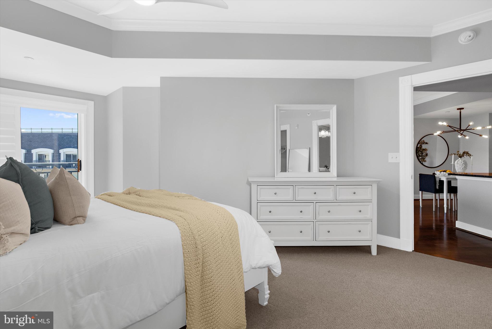 5 Park Place, Unit 702 Annapolis, MD 21401 - Photo 18 of 55 a bedroom with a bed and a dresser