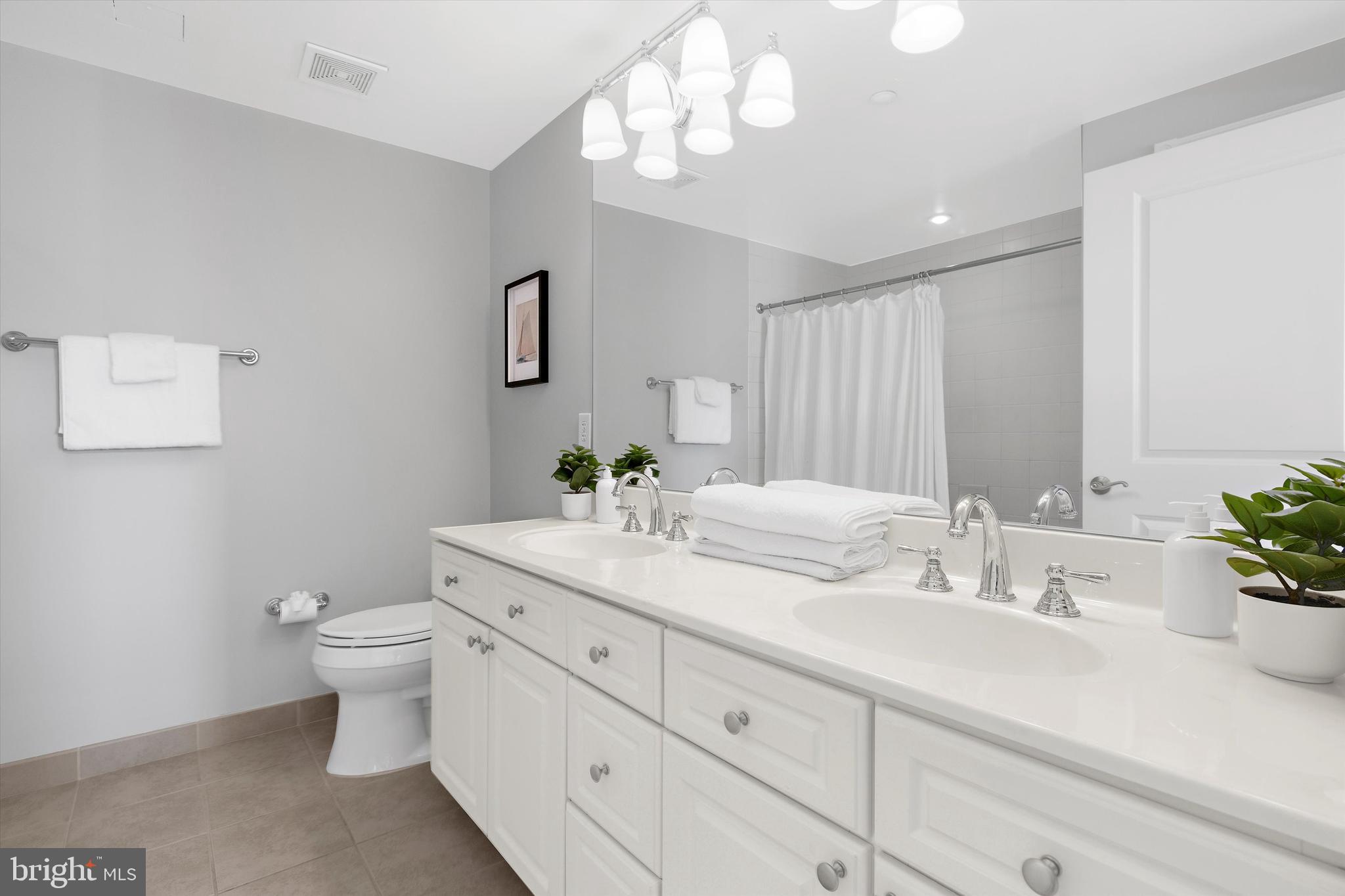5 Park Place, Unit 702 Annapolis, MD 21401 - Photo 21 of 55 a bathroom with a granite countertop sink mirror and toilet