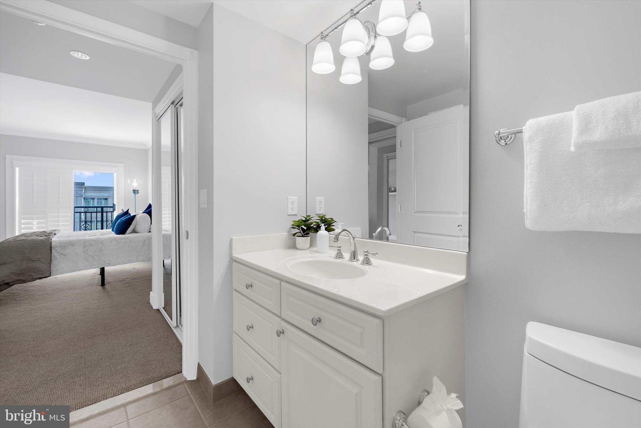 5 Park Place, Unit 702 Annapolis, MD 21401 - Photo 29 of 55 a spacious bathroom with a granite countertop sink and a mirror