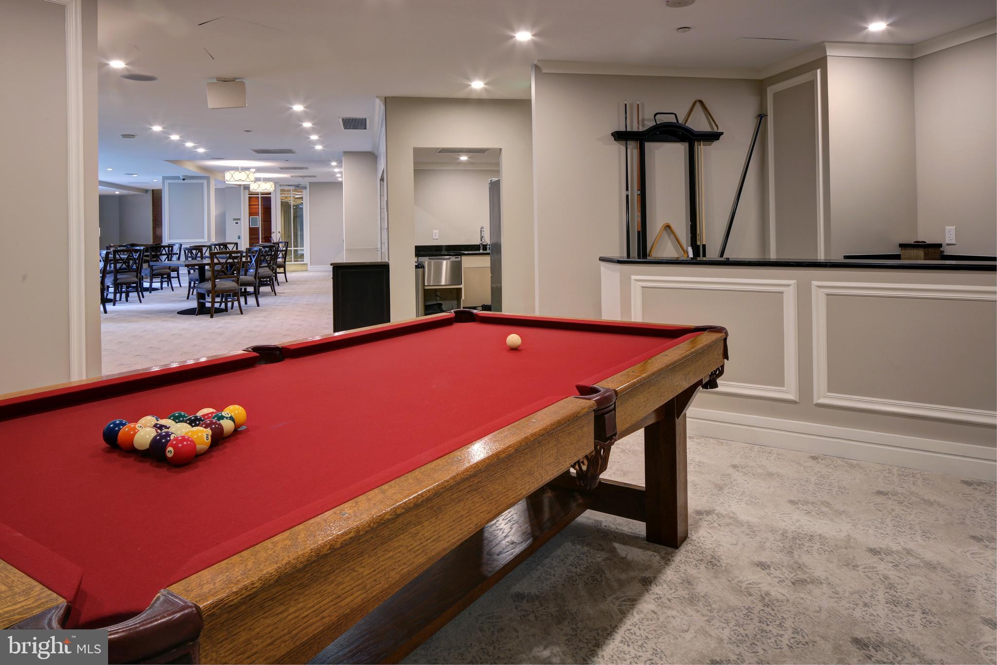 5 Park Place, Unit 702 Annapolis, MD 21401 - Photo 35 of 55 a large kitchen with stainless steel appliances kitchen island granite countertop a dining table and chairs