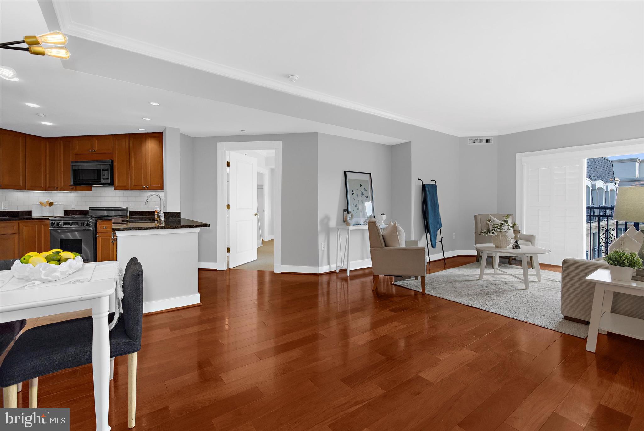 5 Park Place, Unit 702 Annapolis, MD 21401 - Photo 4 of 55 a living room with furniture and a dining table with kitchen view
