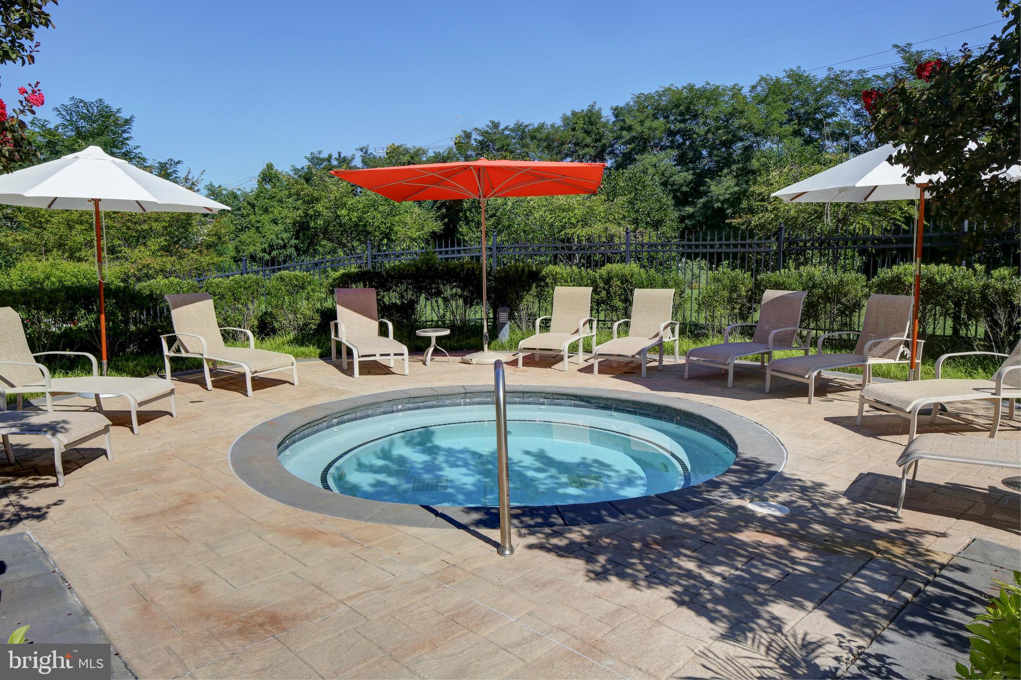5 Park Place, Unit 702 Annapolis, MD 21401 - Photo 41 of 55 a view of a swimming pool with a table and chairs under an umbrella