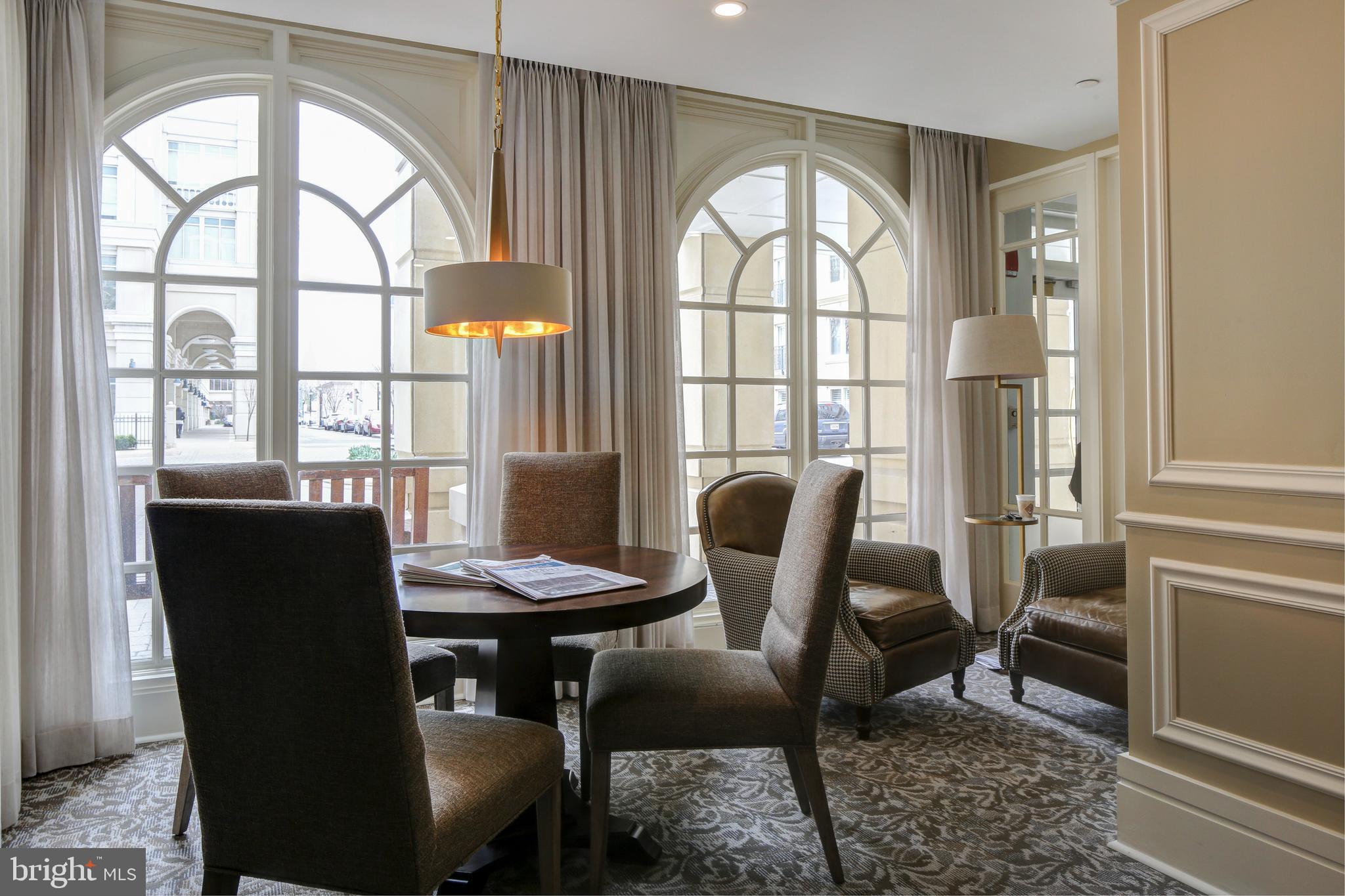 5 Park Place, Unit 702 Annapolis, MD 21401 - Photo 48 of 55 a view of a dining room with furniture a chandelier and wooden floor