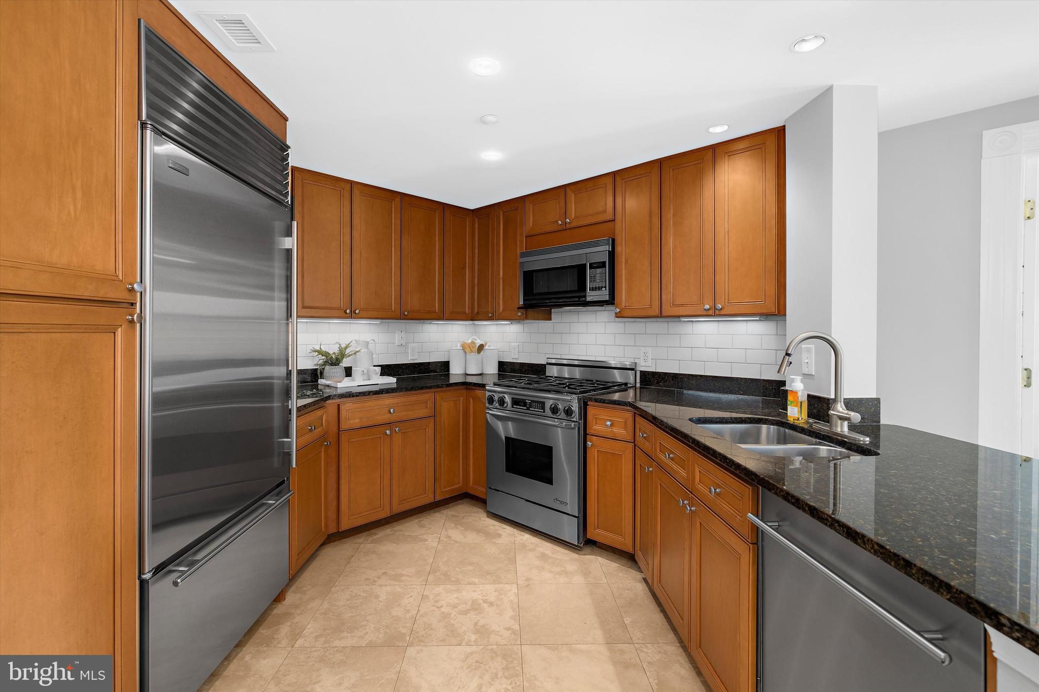 5 Park Place, Unit 702 Annapolis, MD 21401 - Photo 5 of 55 a kitchen with stainless steel appliances granite countertop a sink stove and refrigerator
