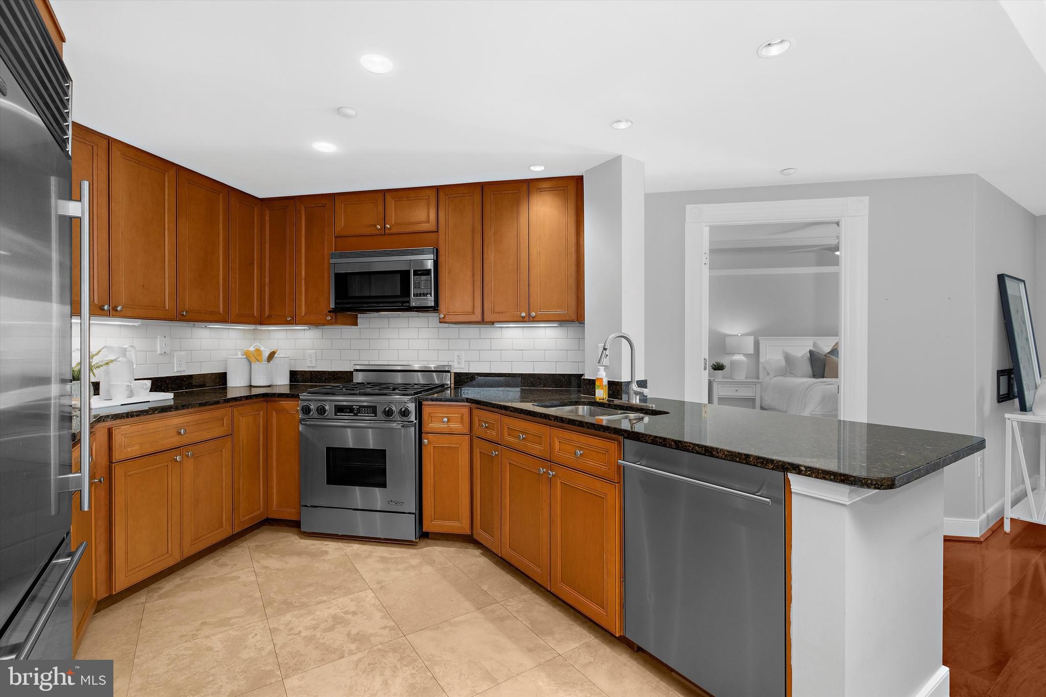 5 Park Place, Unit 702 Annapolis, MD 21401 - Photo 6 of 55 a kitchen with stainless steel appliances granite countertop a sink stove and refrigerator