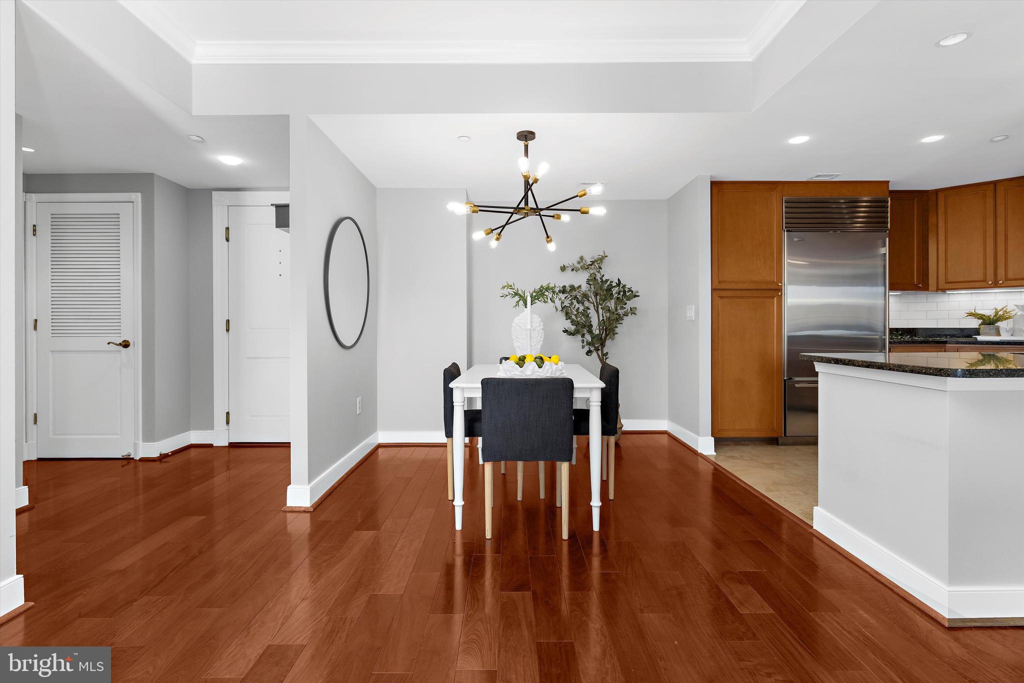 5 Park Place, Unit 702 Annapolis, MD 21401 - Photo 10 of 55 a living room with kitchen island furniture and a chandelier