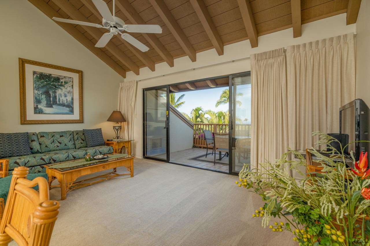 a living room with patio furniture and a flat screen tv