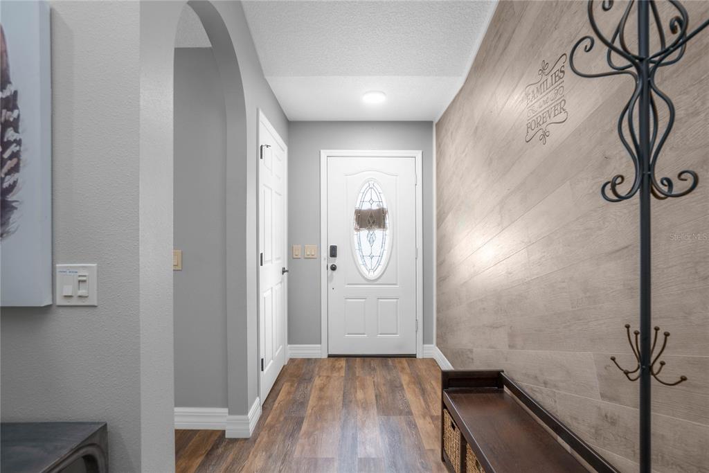 5466 West Tortuga Loop Lecanto, FL 34461 - Photo 7 of 41 a view of a hallway with wooden floor