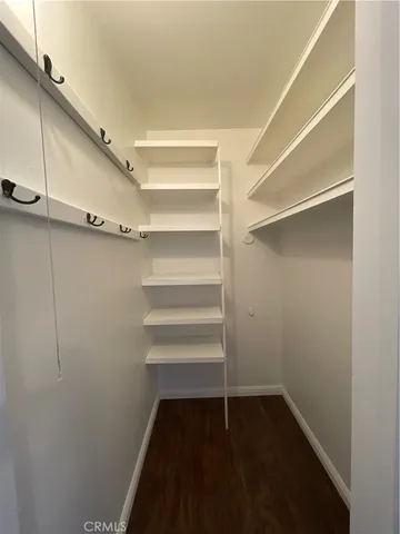 a view of walk in closet with empty racks