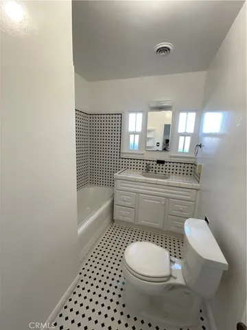 a bathroom with a toilet a sink and a shower