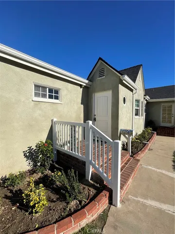 a view of a house with wooden fence