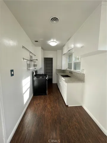a kitchen with a refrigerator and a sink