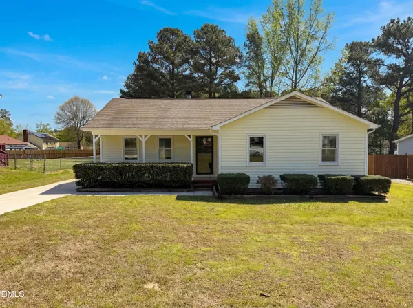 a front view of a house with swimming pool and a yard