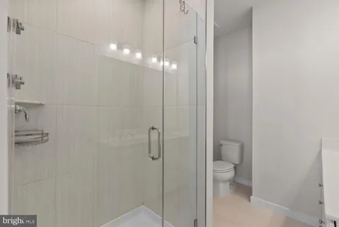 a bathroom with a toilet a sink and shower