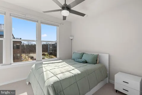 a bedroom with a large bed and a large window