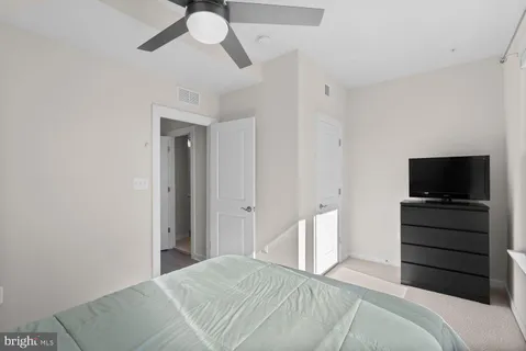 a bedroom with a bed and a flat screen tv