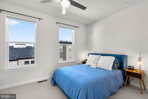 a bedroom with a bed and a painting on the wall