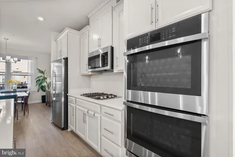 a kitchen with stainless steel appliances a stove microwave and refrigerator