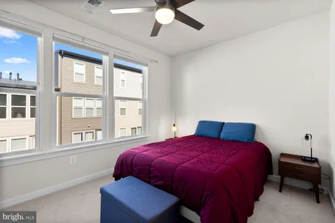a bedroom with a large bed and a large window