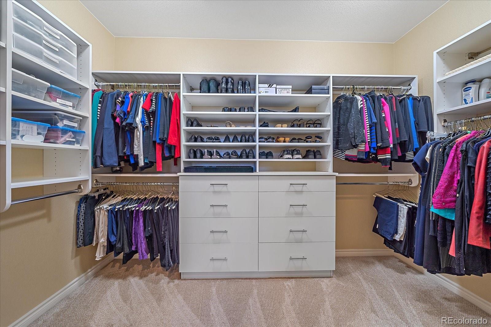 9317 Viaggio Way Highlands Ranch, CO 80126 - Photo 20 of 50 a view of walk in closet with clothes and shoes