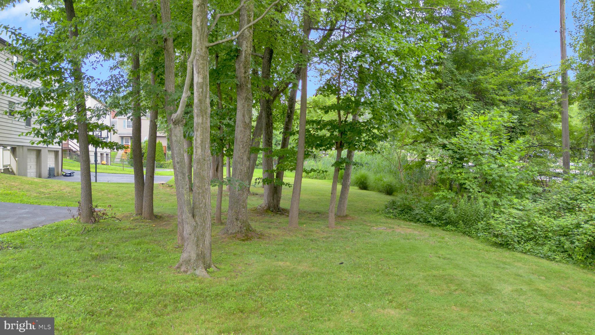 70 St Davids Road Springfield, PA 19064 - Photo 34 of 39 a backyard of a house with lots of green space and garden