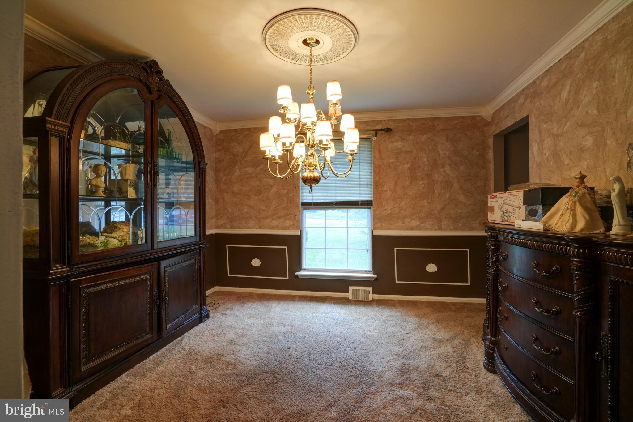 70 St Davids Road Springfield, PA 19064 - Photo 6 of 39 a living room with furniture a fireplace and a chandelier