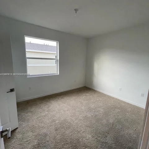 a view of a backyard with potted plants