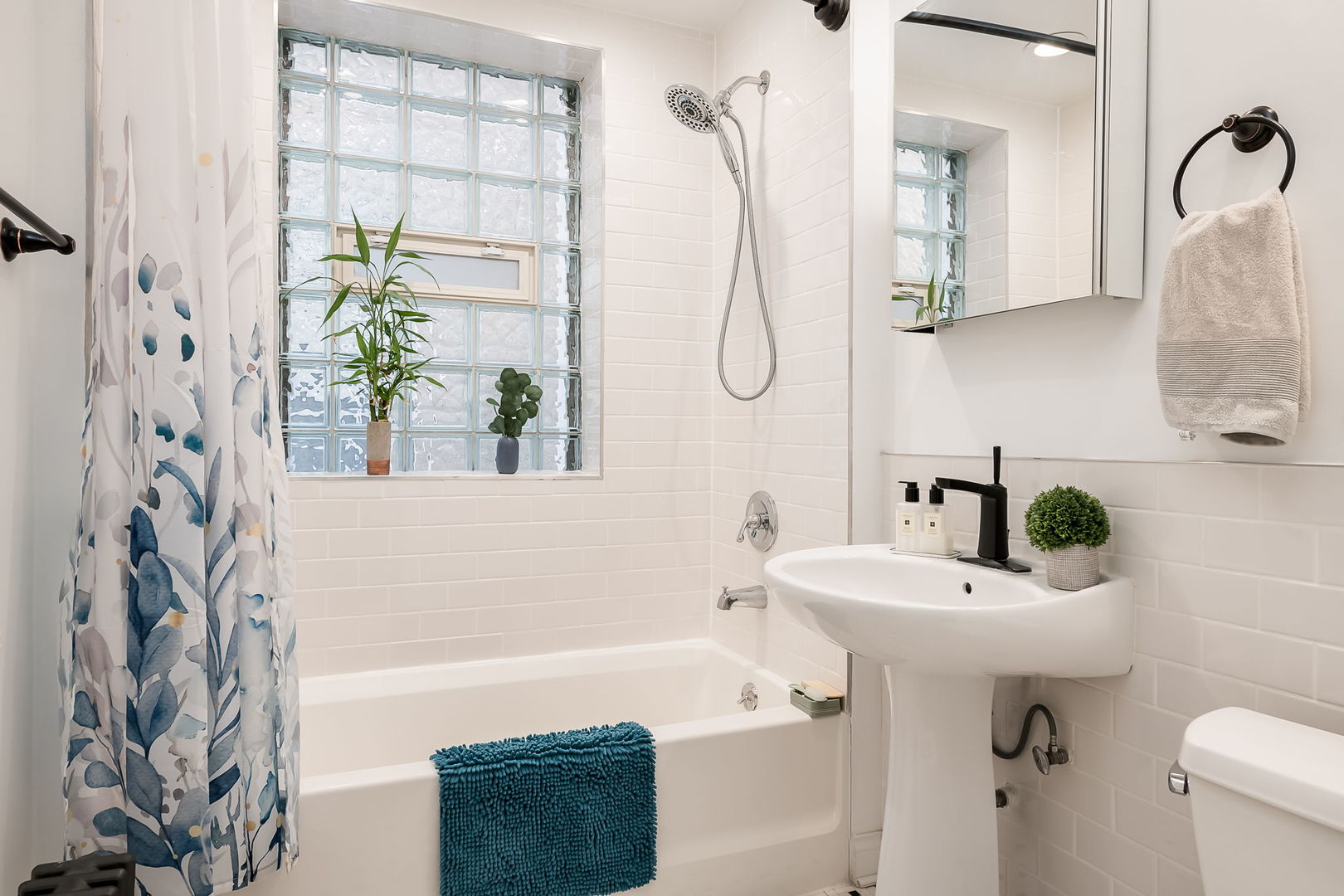 Undisclosed Address Chicago, IL 60657 - Photo 15 of 24 a bathroom with a sink a mirror and a shower