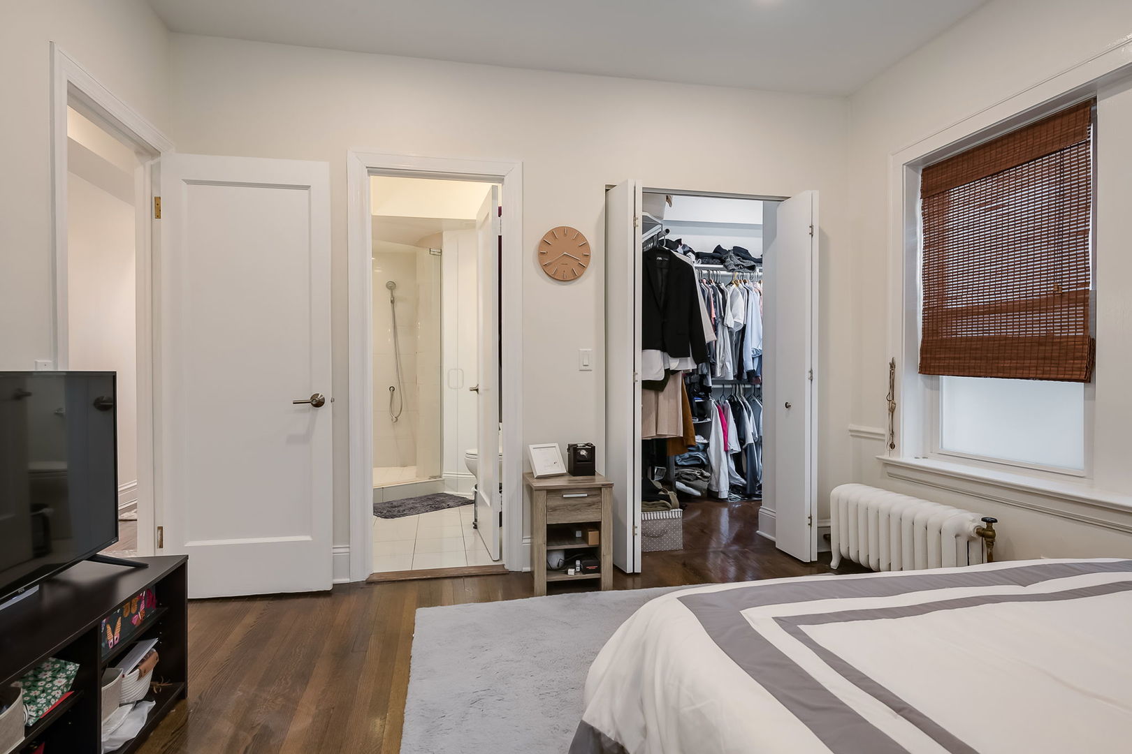 Undisclosed Address Chicago, IL 60657 - Photo 17 of 24 a bedroom with bed and a flat tv screen on dresser