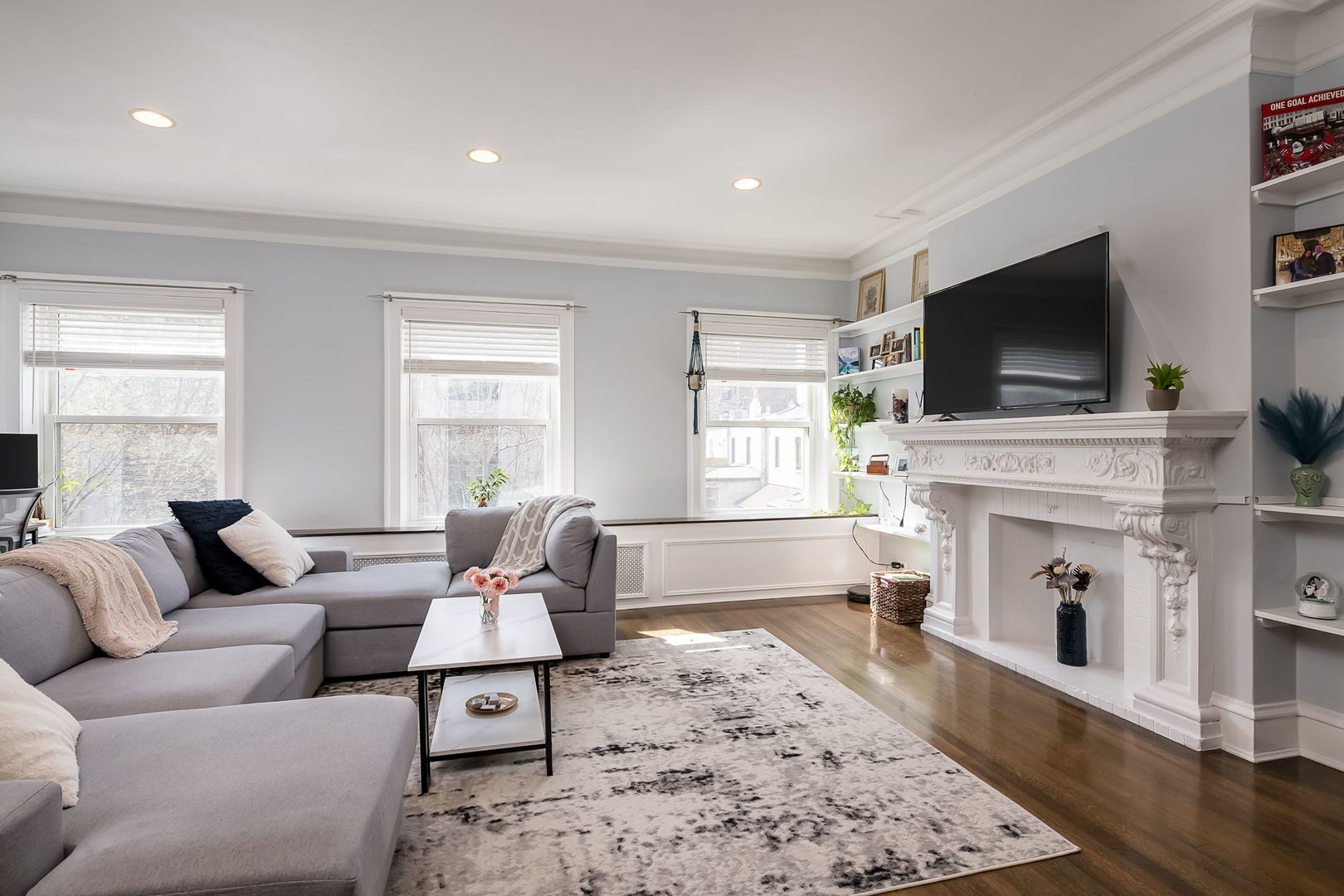 Undisclosed Address Chicago, IL 60657 - Photo 6 of 24 a living room with furniture a flat screen tv and a fireplace